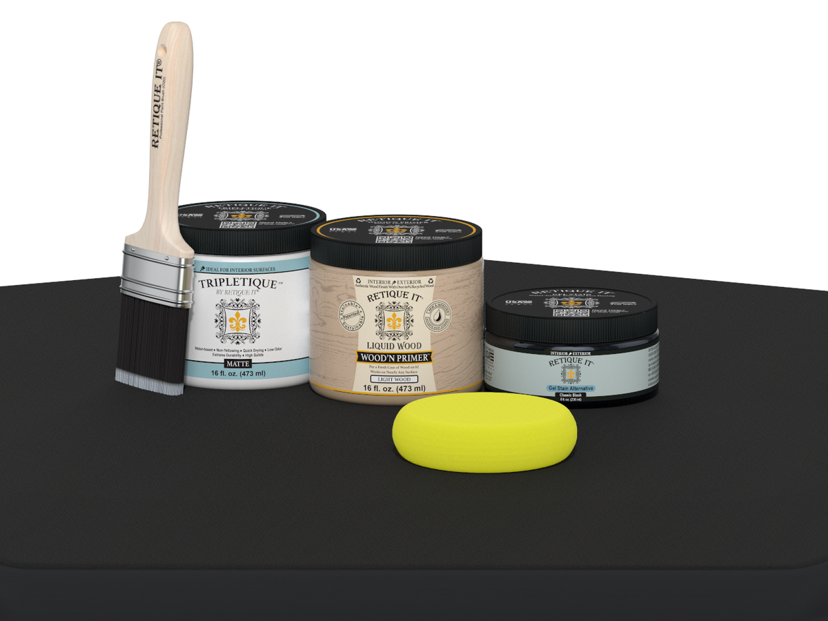 Collection of paint-related products including jars, a brush, and a sponge on a black surface.