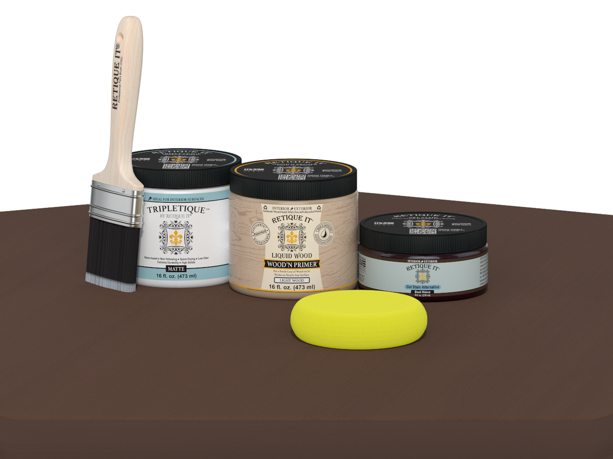 Collection of paint-related products including a brush, jars, and a sponge on a brown surface.