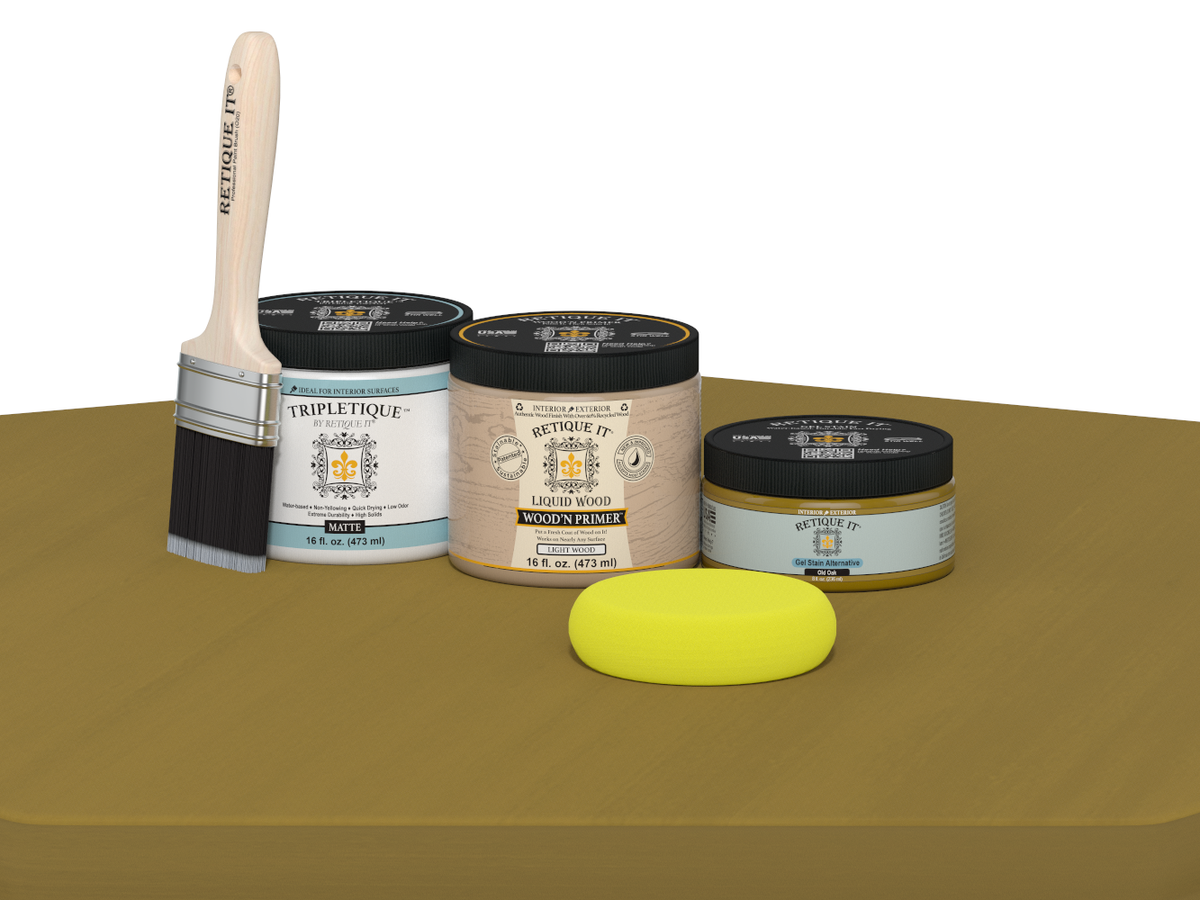 Painting supplies including a brush, jars of paint, and a sponge on a brown surface.