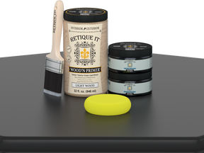 Retique It wood primer set with a brush and sponge on a gray surface