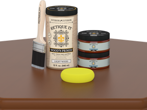 Retique It wood primer with a brush and sponge on a brown surface