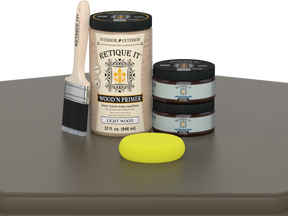 Retique It wood primer set with a brush and sponge on a gray surface