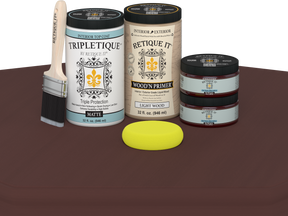 Paint cans and a brush on a brown surface with a white background