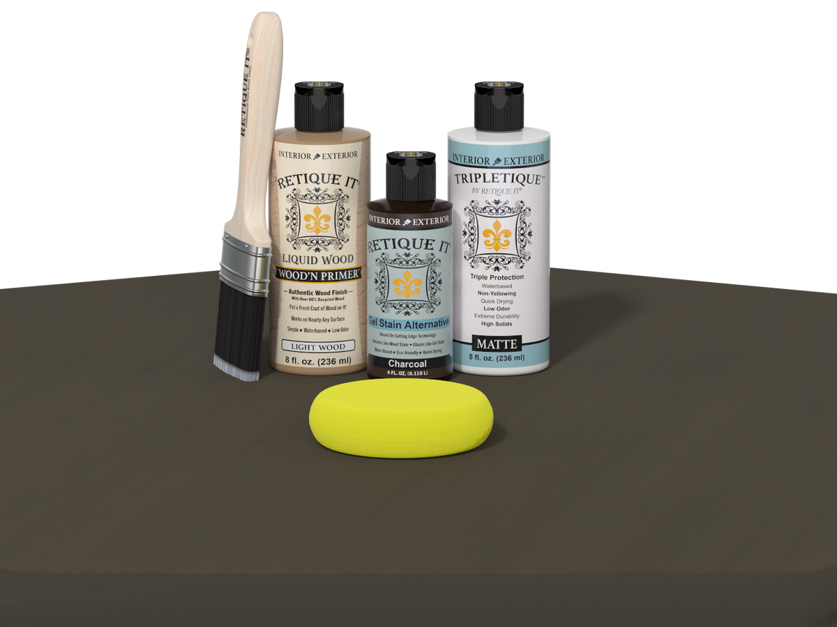 Collection of art supplies including bottles, a brush, and a sponge on a dark surface.