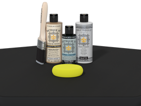 Collection of Eticketit paint bottles and a yellow sponge on a black surface