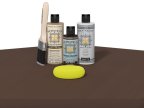 Collection of Etiketique paint bottles and tools on a brown surface with a white background