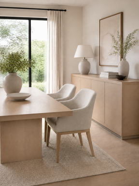 Neutral dining room with a light wood table and sideboard.